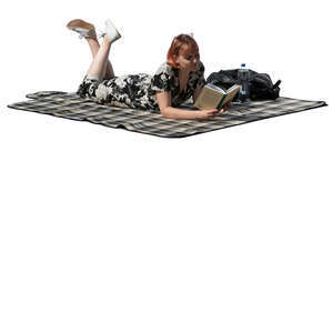 cut out young woman lying on the ground and reading a book