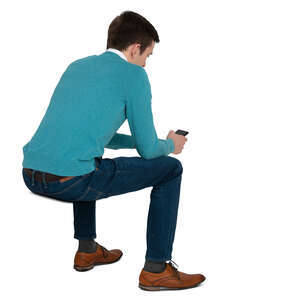 cut out man sitting and looking smth on his phone