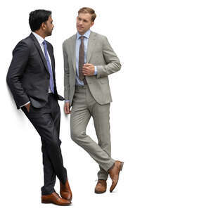 two businessmen standing and leaning against the wall and talking