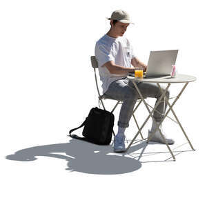 young man sitting in a cafe and working with a laptop