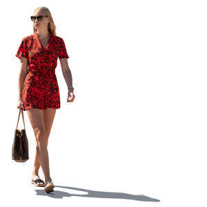 cut out sidelit woman in a red jumpsuit walking