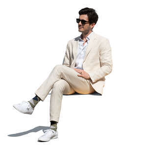 cut out man in a white suit sitting