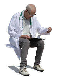 cut out older male doctor sitting and reading some papers