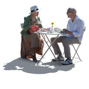 cut out backlit elderly couple sitting in a cafe