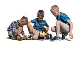 three cut out boys playing with toy cars