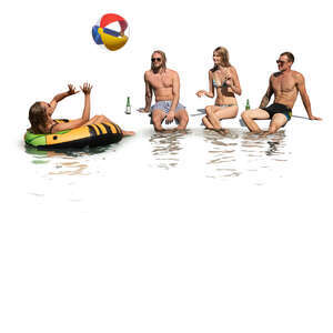 cut out group of young people sitting by the pool and drinking and playing with a beach ball