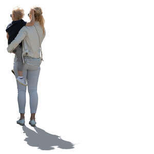 cut out backlit woman standing and holding her son in her arms