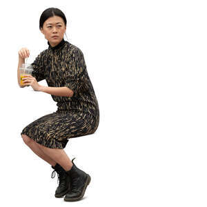 cut out asian woman sitting and drinking juice