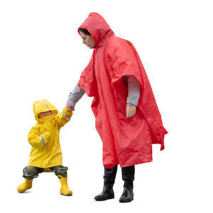 mother and son in raincoats standing hand in hand