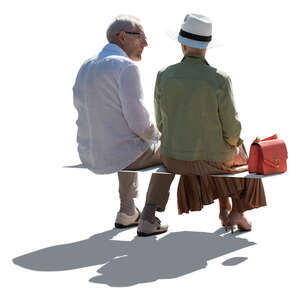 two cut out backlit elderly people sitting and talking