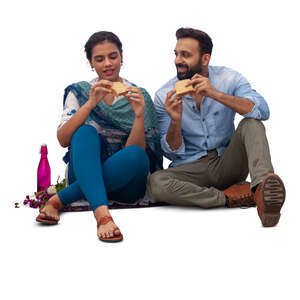 cut out indian man and woman sitting and eating sandwiches