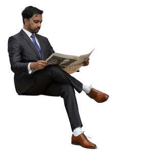 cut out indian businessman sitting and reading a newspaper