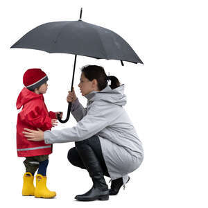 cut out mother squatting and talking to her little son in the rain