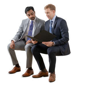 two cut out businessmen sitting and reading some papers