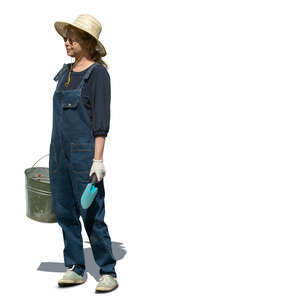 cut out garden worker in denim ovaralls and holding a bucket standing