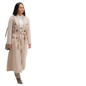 cut out woman in a beige overcoat walking