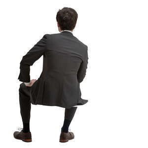 cut out man in a black suit sitting seen from behind