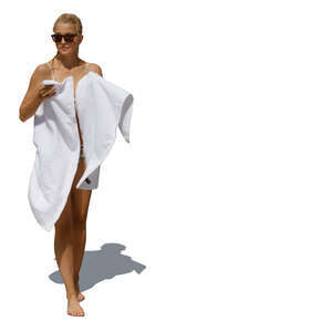 woman coming from swimming drying herself with a  white towel