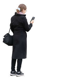 cut out young woman in a black overcoat standing