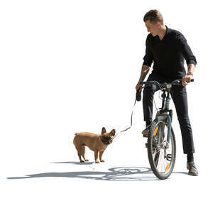 sidelit man with a dog riding a bike