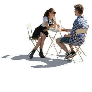 backlit image of a cafe table with man an woman sitting and talking