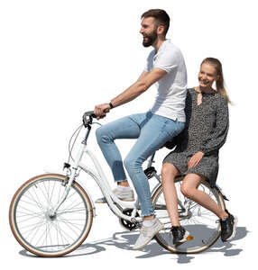 man riding a bike with a woman sitting on the rack