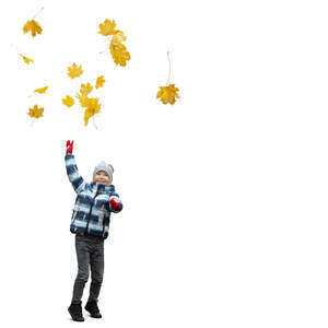 cut out little boy playing with fallen leaves