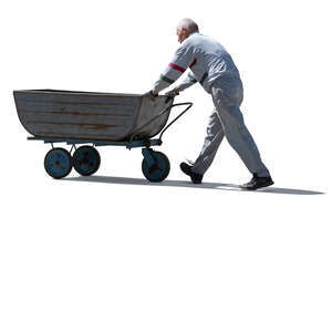 cut out older man pushing a large wheelbarrow