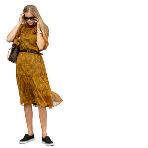 cut out woman in a dress standing and talking on a phone