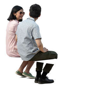 cut out man and woman sitting seen from back angle