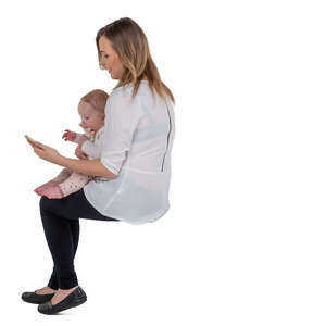 cut out woman holding a baby sitting and making a phone call