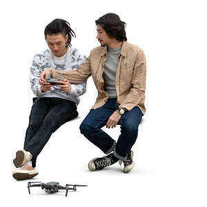 two cut out men flying a drone