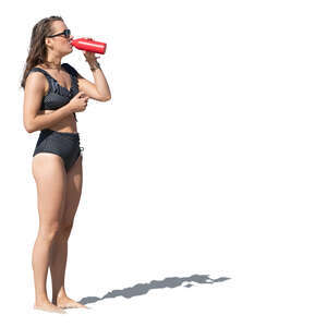 cut out woman standing on the beach and drinking water