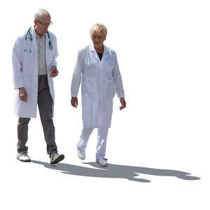 two cut out backlit doctors walking