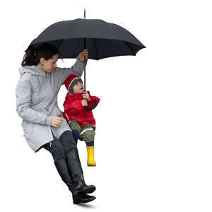 cut out woman sitting with her son under an umbrella