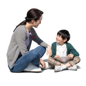 cut out mother and son sitting on the ground and talking