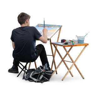 cut out young man sitting and painting