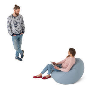 cut out woman sitting in a bean bag talking to a man standing by