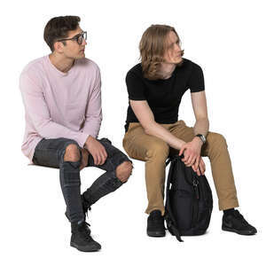 two cut out young men sitting