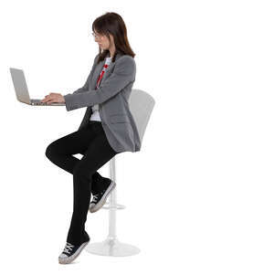 cut out woman sitting on a barstool and working with laptop