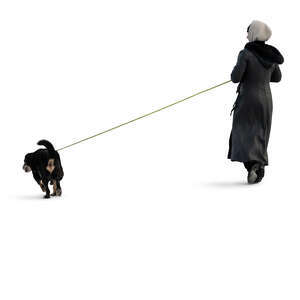 cut out woman in a winter overcoat walking a dog