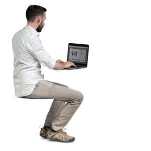 cut out man sitting at a table and working with laptop