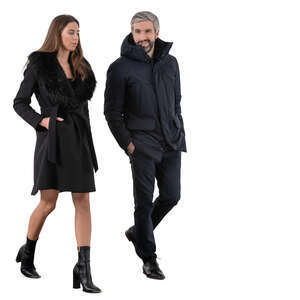 cut out man and woman wearing black overcoats walking