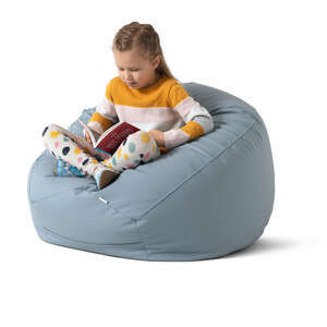 cut out little girl sitting in a bean bag and reading a book