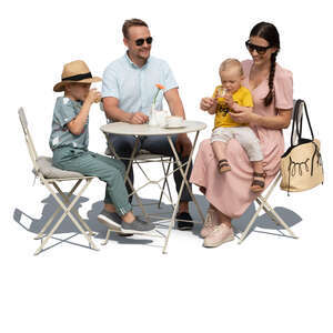 family with two kids sitting in a cafe on a summer day