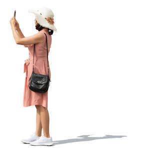 asian woman with a hat standing and taking a picture