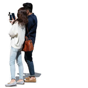 young asian couple looking at their phones together