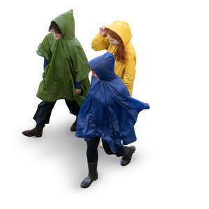 three cut out women in raincoats walking seen from above