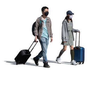 cut out asian man and woman with trolley bags and wearing face masks walking
