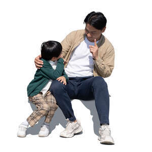 cut out asian father and son sitting and talking